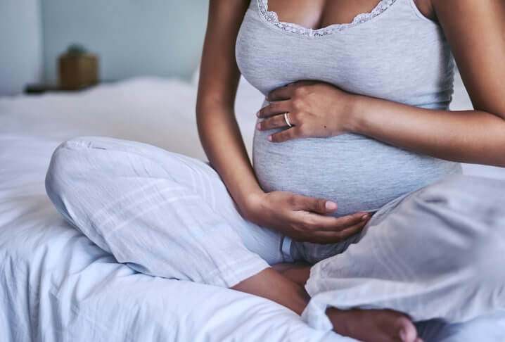 Shot of an expectant woman at home