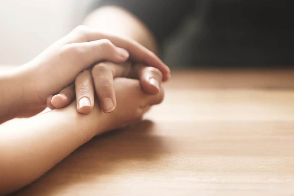 Friends holding hands