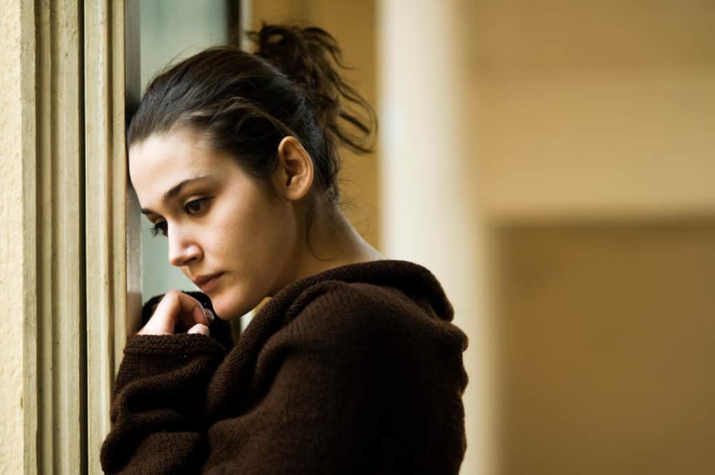 Woman leaning against window