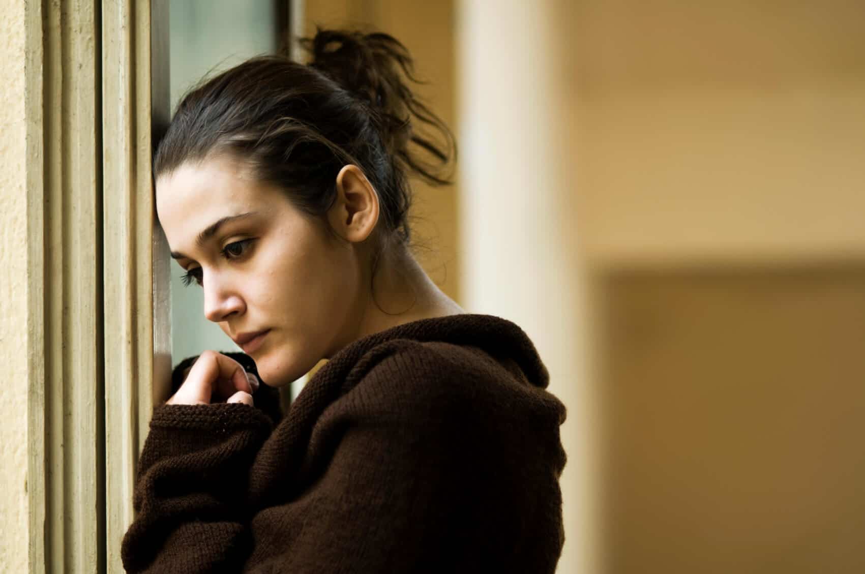 Woman leaning against window