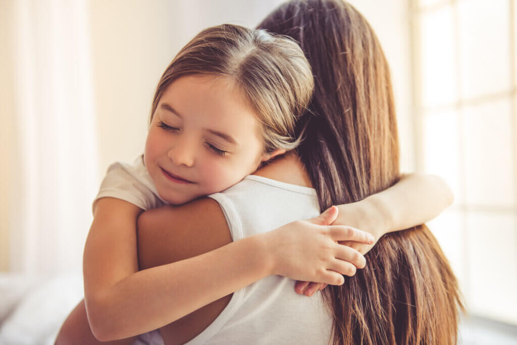 Daughter hugs mom