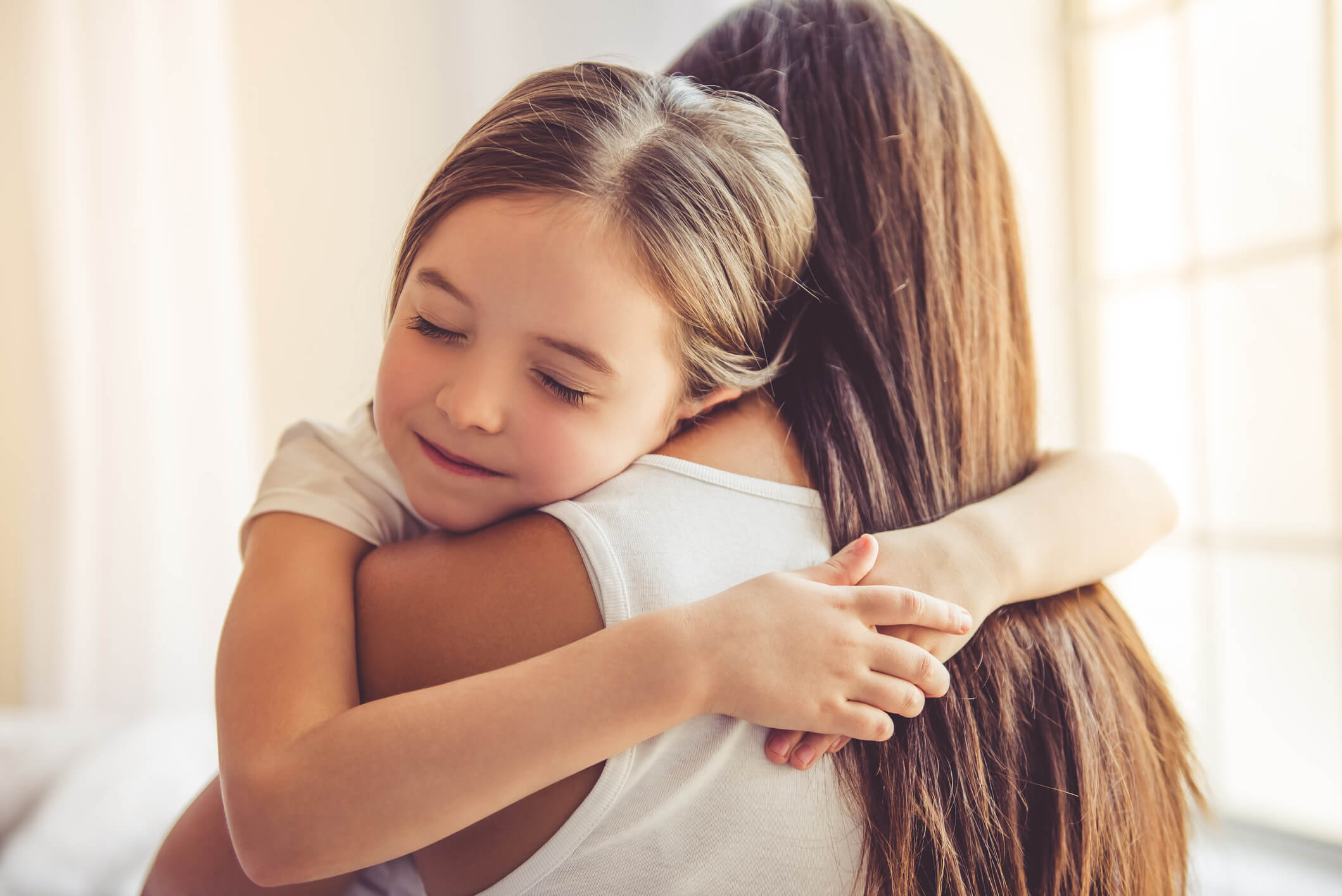 Daughter hugs mom