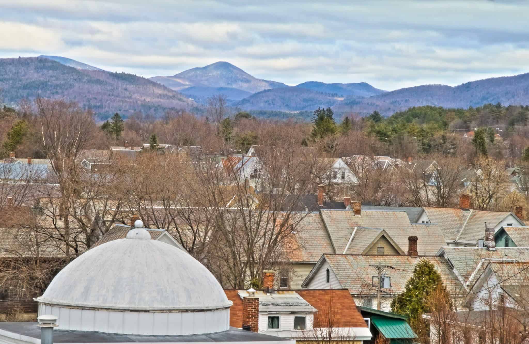 Rooftops of houses with mountains in the background