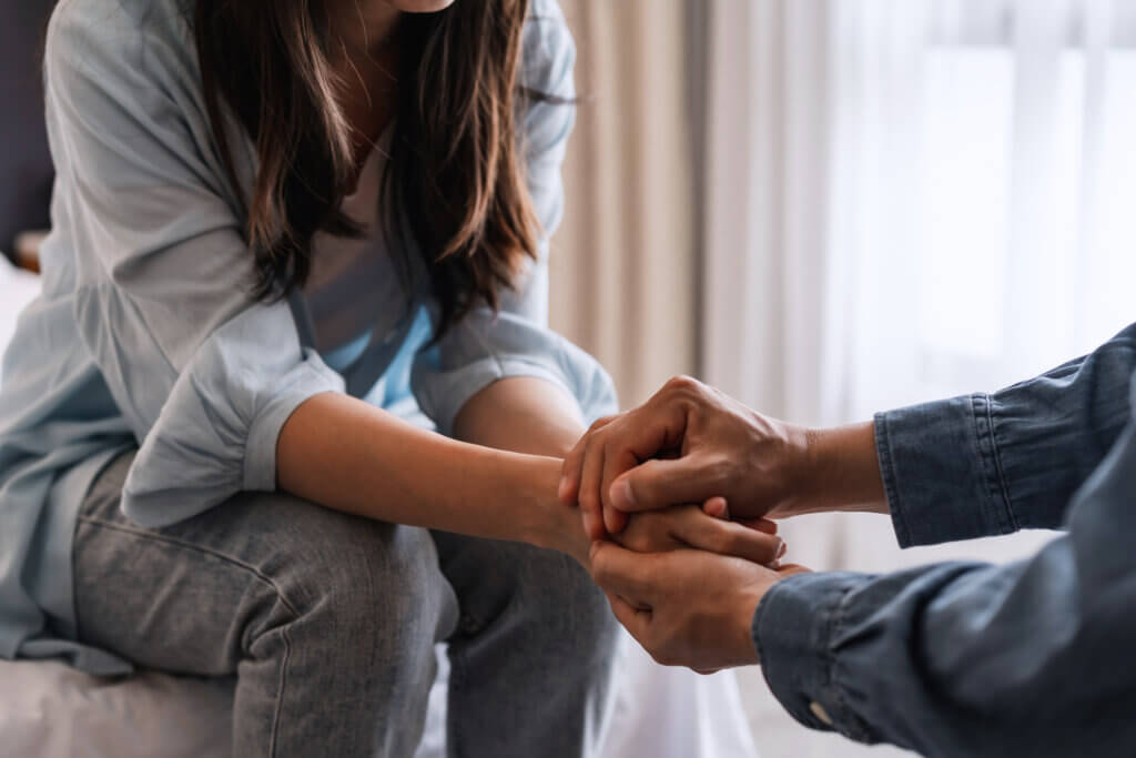 Woman and man hold hands